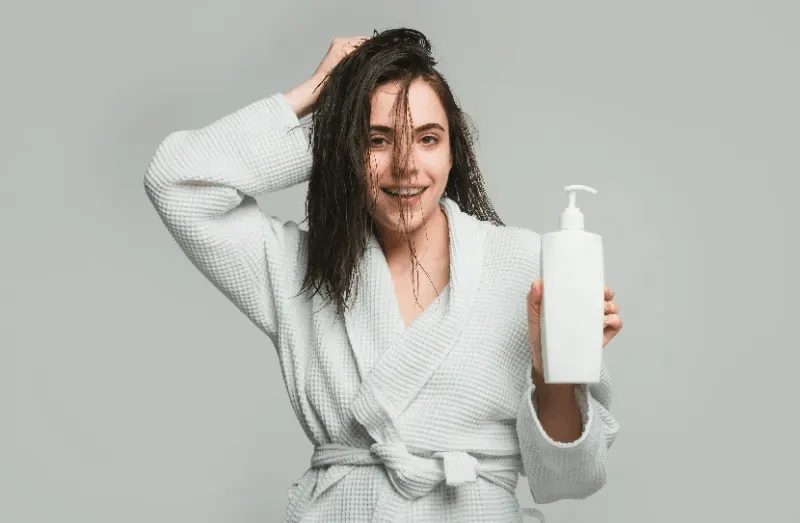 The image representing the use of a hair fall shampoo aimed at improving hair health.